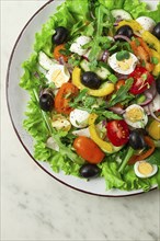 Vegetable salad, with quail eggs and olives, fresh, close-up, no people