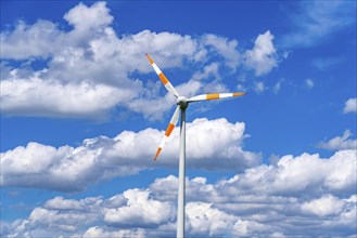 Wind turbine, wind energy plant from the manufacturer Enercon, blue sky with many white clouds,