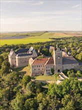 Aerial view of a wide medieval castle, embedded in green landscape and open terrain, Allstedt,