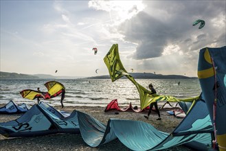 Kitesurfers and windsurfers in sun and storm, Reichenau Island, Untersee, Lake Constance,