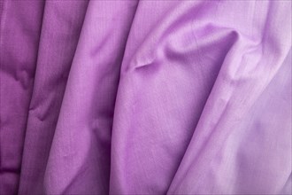 Fragment of cotton purple tissue. Top view, natural textile background and texture. wave concept,