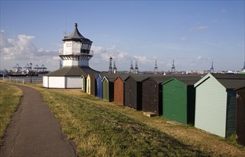 Colourful seaside beach huts and Low lighthouse maritime museum, Harwich, Essex, England, United