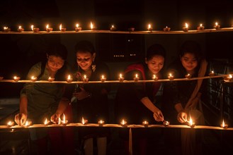 Students of Cotton University lighting diya (Clay lamp) on the occasion of Diwali Festival, on