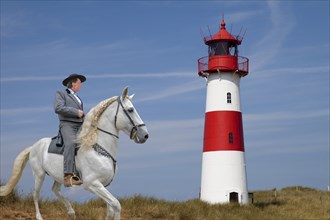 Rider in front of lighthouse on Sylt Germany