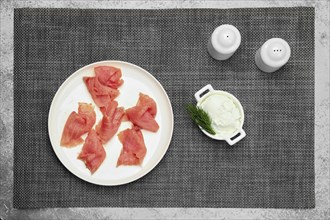 Top view of slices of smoked salmon on a plate