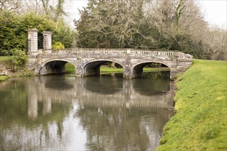 Historic ornamental stone bridge over River Avon in Amesbury Abbey Park, Amesbury, Wiltshire,