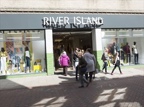 River Island shop shoppers walking in street, Tavern Street, Ipswich, Suffolk, England, UK