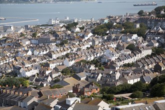 High density housing in Fortuneswell, Isle of Portland, Dorset, England with Weymouth harbour in