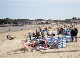 Holidaymakers enjoying sunshine on the sandy beach at Weymouth, Dorset, England, United Kingdom,