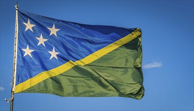 The flag of Solomon Islands, Solomon Islands, island nation in the South Seas, flutters in the