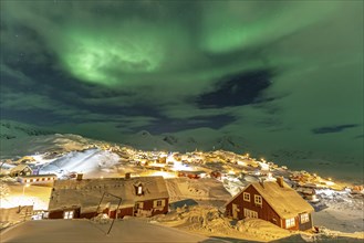 Northern Lights, Aurora borealis over houses, Inuit settlement, Winter, Tasiilaq, East Greenland,