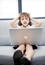 A little girl with a laptop is tired, Studio