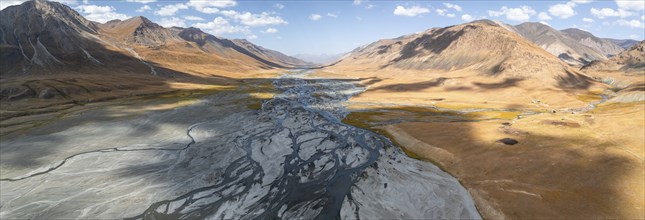 Aerial view, Burkhan mountain valley with meandering river, barren dramatic mountain landscape,