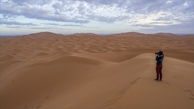 Woman photographed in desert, dunes, Erg Chebbi, Sahara, Merzouga, Morocco, Africa