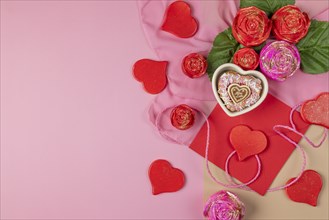 An arrangement of decorative hearts, roses and an envelope, heart-shaped cupcake, ideal for