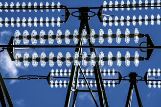 Insulators made of glass on a high-voltage line, they hang on the pylons as a suspension device