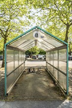 Shelter for shopping trolleys, empty, abandoned in a car park, no longer needed, shop closed