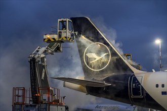 Winter at Frankfurt Main Airport, FRA, Lufthansa aircraft being de-iced by de-icing vehicles,