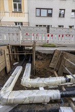 Construction site of a district heating house connection, pipes, insulated, are laid from a central