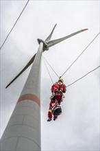 Height rescuers from the Oberhausen fire brigade practise abseiling from a wind turbine from a