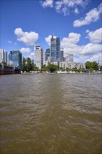 Main and skyscrapers under blue sky with cumulus clouds in Frankfurt am Main, Hesse, Germany,