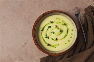 Mashed potatoes, with green butter and micro greenery, homemade, on a beige table, no people, top