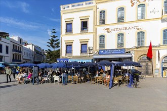 People sitting outside cafe restaurant, Place Moulay Hassan, Essaouira, Morocco, north Africa,