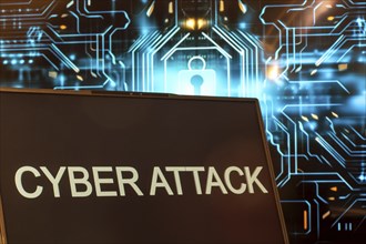 Cyber attack symbol: Laptop in front of a virtual computer background