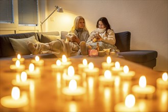 Symbolic image energy saving, cold winter, energy crisis, cold flat, mother and daughter lying on