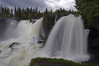 Spectacular waterfalls in the middle of a dense forest under a cloudy sky, Ronja the Robber's