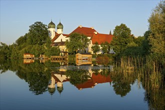 Romanesque Benedictine Abbey Seeon Monastery, monastery church St. Lambert with reflection in the