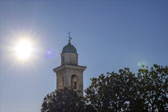 Church Tower of San Zenone Against Blue Clear Sky and Sunbeam in Campione d'Italia, Lombardy,