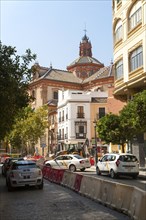 Traffic in street near Iglesia Santa María Magdalena in central Seville, Spain, Europe