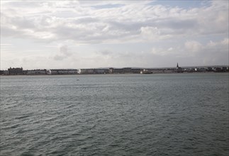 Distant view from the sea of buildings on the seafront in Weymouth, Dorset, England, United