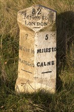 Old milestone road marker on A4 road Beckhampton, Wiltshire, England, UK