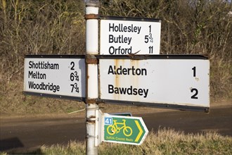 Rural country road dishes with distances, Suffolk, England, UK between Alderton and Hollesley