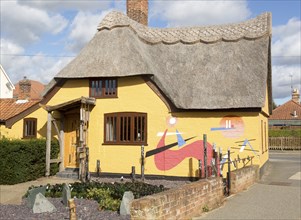 Historic thatched cottage painted artistically, Hollesley, Suffolk, England, UK