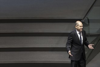 Olaf Scholz (SPD), Federal Chancellor, arrives in the plenary chamber of the German Bundestag in