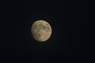 A full moon in the night sky, England, United Kingdom, Europe