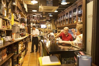 People inside a traditional cafe bar in Seville, Spain, Europe