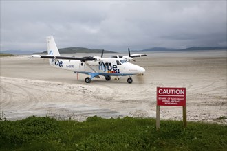 Flybe plane on sandy airstrip Isle of Barra airport, Barra, Outer Hebrides, Scotland, UK