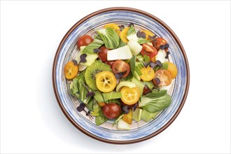 Vegetarian salad of pac choi cabbage, kiwi, tomatoes, kumquat, microgreen sprouts isolated on white