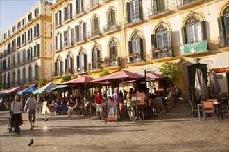 People enjoying a sunny spring afternoon in bars on the Plaza de la Merced, Malaga Spain