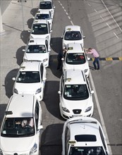 Line of white taxis queuing outside Malaga airport, Spain, Europe