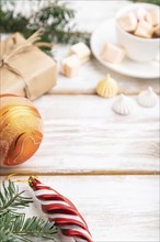 Christmas or New Year composition. Decorations, box, balls, cinnamon, fir and spruce branches, cup