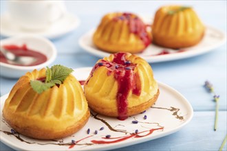 Semolina cheesecake with strawberry jam, lavender, cup of coffee on blue wooden background. side