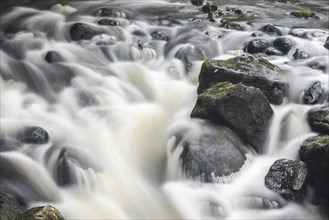 Detail of water flowing over boulders in the River Garry in Glengarry Forest, Lochaber, Scottish