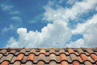 Close up of roof with red ceramic tiles and blue sky. KI generiert, generiert, AI generated