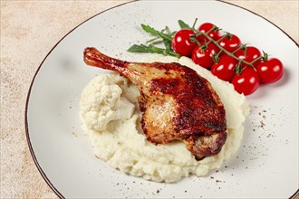 Fried duck shank, cauliflower puree, cherry tomatoes, homemade, no people