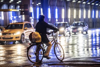 Street at the central station, cyclist, rainy weather, city centre, in the evening, Essen, North